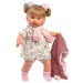 Llorens: Păpușa plângătoare Alexandra de 42 cm cu suzetă, îmbrăcată într-o jachetă roz tricotată și fustă cu flori.